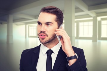 Poster - Composite image of smart businessman speaking on the phone