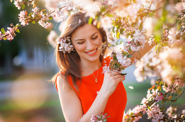 Beautiful woman in the flowering spring garden