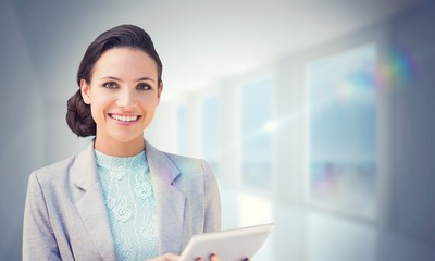 Poster - Composite image of brunette using tablet pc
