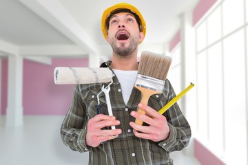 Poster - Composite image of screaming manual worker holding various tools