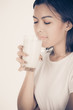© Nonwarit - Laughing young woman with a glass of milk