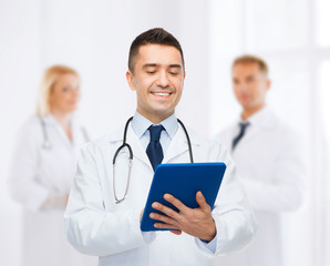 Poster - smiling male doctor with tablet pc at hospital