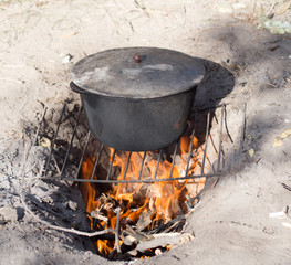 cooking fish soup on the fire