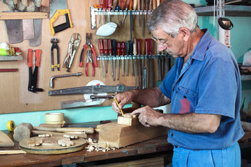 Wall Mural - work cabinetmaker marking handcrafted wooden pieces in garage at