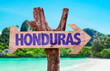 Honduras wooden sign with beach background