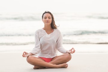 Canvas Print - Sporty brunette sitting in lotus pose