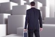 © WavebreakMediaMicro - Composite image of rear view of businessman holding a briefcase