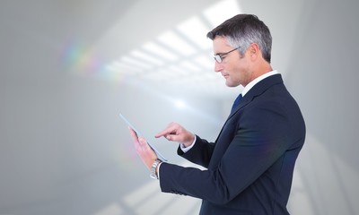 Wall Mural - Composite image of mid section of a businessman touching tablet