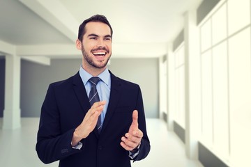 Poster - Composite image of happy businessman standing and clapping