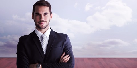 Poster - Composite image of smiling businessman posing with arms crossed
