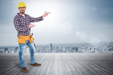 Poster - Composite image of handyman showing something