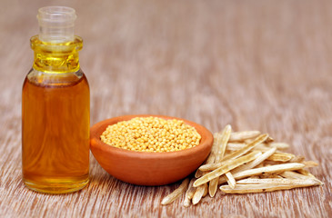 Wall Mural - Golden Mustard with empty pods and oil in a bottle