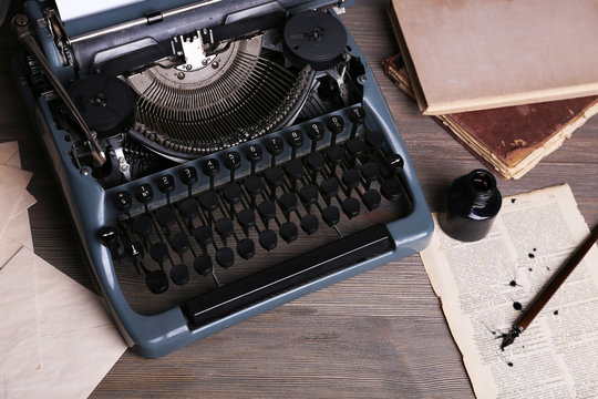 Retro typewriter on wooden background