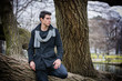 © theartofphoto - Stylish Man Leaning on Tree Trunk Looking Afar