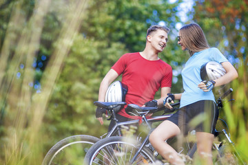 Wall Mural - Two Professional Cycling Athletes Standing Together Outdoors wit