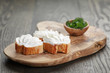 homemade appetizing crostini with soft cheese cream herbs