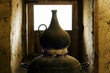 traditional alembic distiller with window in old adobe  house