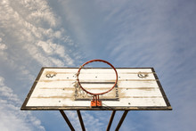 Old Street Basketball Basket With A Cloudy Blue Sky
