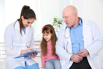 Poster - Little girl and doctors in hospital