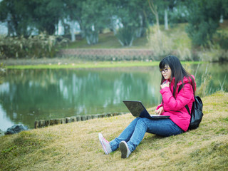 Asian adult student sitting outdoor