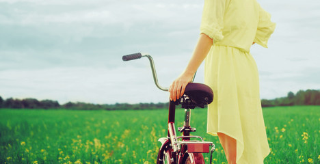 Canvas Print - Girl walking with bike outdoor in summer