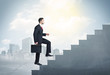 © ra2 studio - Businessman climbing up a concrete staircase concept