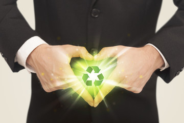 Wall Mural - Hands creating a form with recycling sign