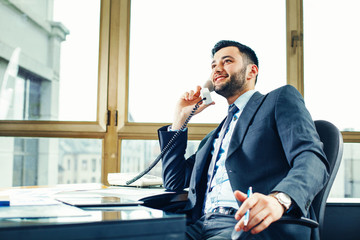 young businessman talking on the phone at the office