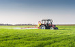 © Dusan Kostic - Tractor spraying wheat field