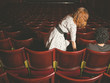 © LoloStock - Woman taking her seat next to man in auditorium