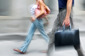 Wall Mural - motion blurred business people walking on the street