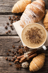 Wall Mural - Hot coffee and pastries on a wooden background