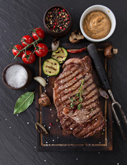 Beef rump steak on black stone table