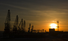 Port Cranes On Sunset