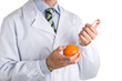 © Vivida Photo PC - man in medical white coat makes an injection to orange