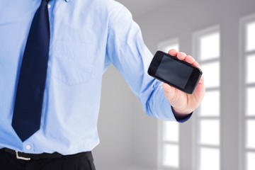 Wall Mural - Composite image of close up of businessman holding a phone