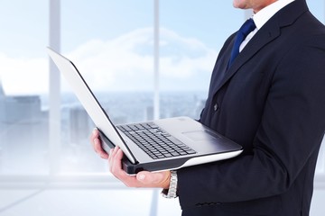 Poster - Composite image of businessman with watch using tablet pc