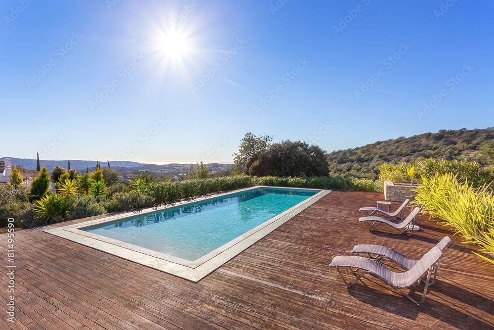 Luxury swimming pool for holidays. In the park with the sun. - obrazy, fototapety, plakaty 