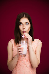 Poster - Young pretty woman drinking yogurt