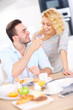 © Kalim - Happy couple eating breakfast