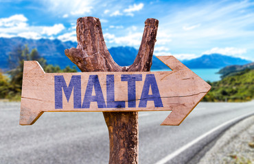 Wall Mural - Malta wooden sign with road background