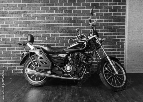 Fototapeta na wymiar Motorcycle in front of Interior Brick Wall