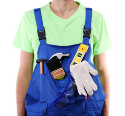 Wall Mural - Man in coveralls with tools in his pocket isolated on white