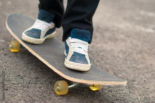 Fotografie, Obraz Skateboarder feet in sneakers on a skateboard.