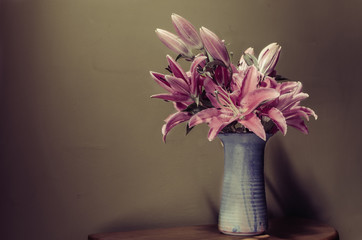 Pink lilies in a blue vase