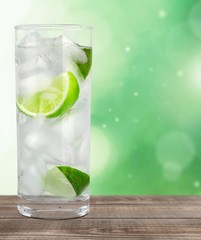 Wall Mural - Vodka. Cocktail with ice and lime slice isolated on white