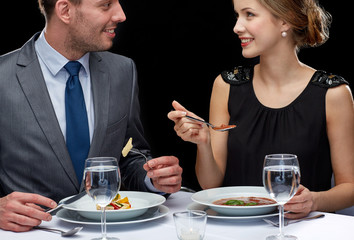 Wall Mural - close up of couple talking at restaurant