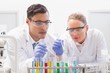 © WavebreakMediaMicro - Focused scientists examining test tube