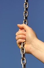 Woman hand and steel chain