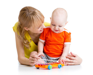 smiling child and mom playing with musical toy